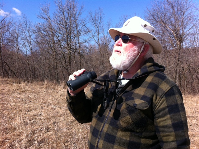 Man with Beard and Hat Looks for Raptors with Binoculars