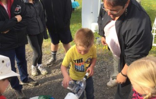 Boy Pours Salmon Down Spout into River