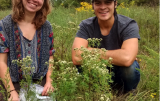 Two Young People Smile in Grasslands at Cedar Haven Farm