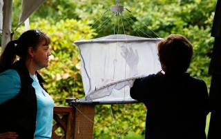 Intern Sarah Woodfield and Volunteer Inspect Bird Feeder