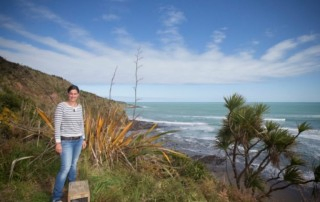 Woman Stands at New Zealand Coast