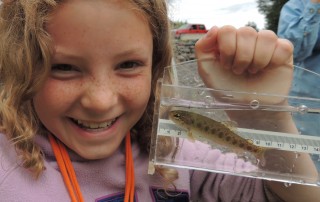 Young Verbeek Holds Salmon Fry in Viewfinder