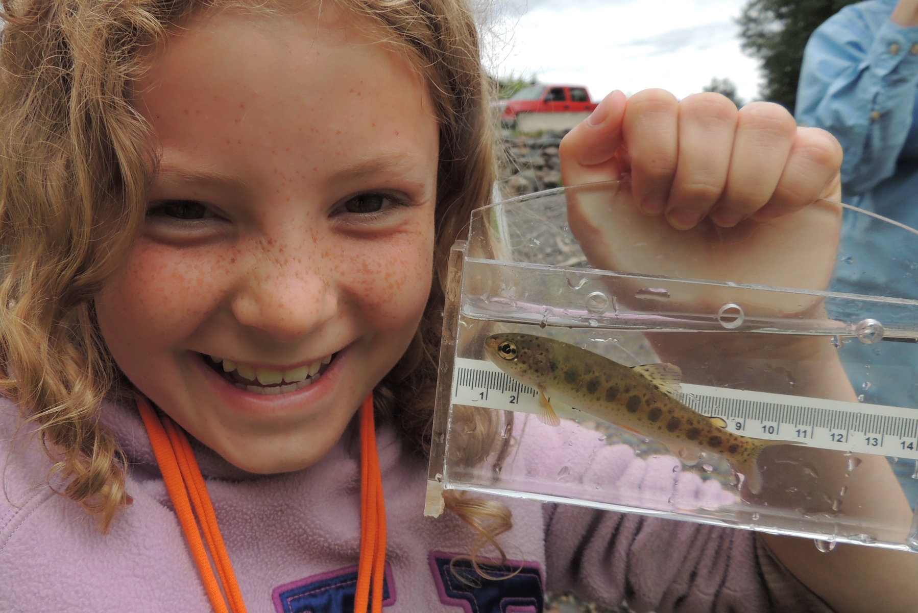 Young Verbeek Holds Salmon Fry in Viewfinder