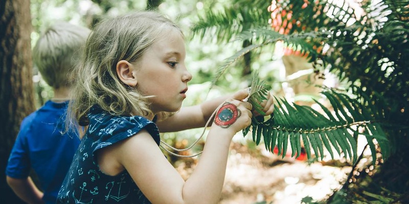 Young Girl Examines Fern