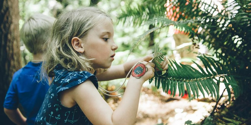 Young Girl Examines Fern
