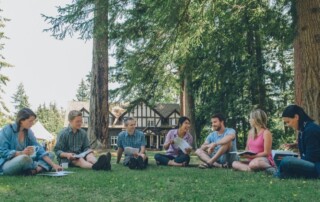 Group shot of adult education group sitting on the grass together at the Brooksdale Environmental Centre