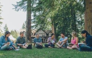 Group shot of adult education group sitting on the grass together at the Brooksdale Environmental Centre