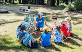Children sitting in a circle being taught about creation