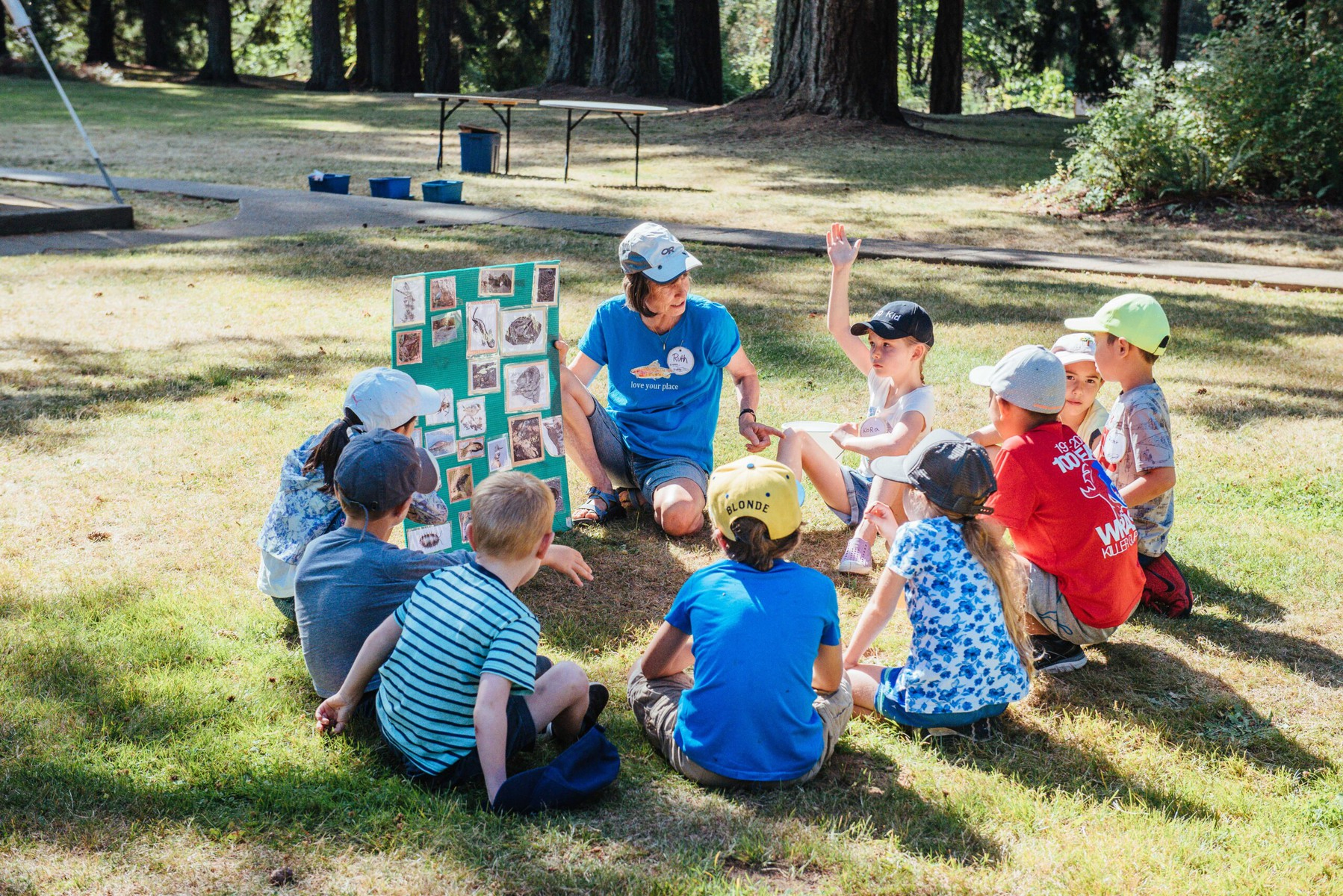Children sitting in a circle being taught about creation