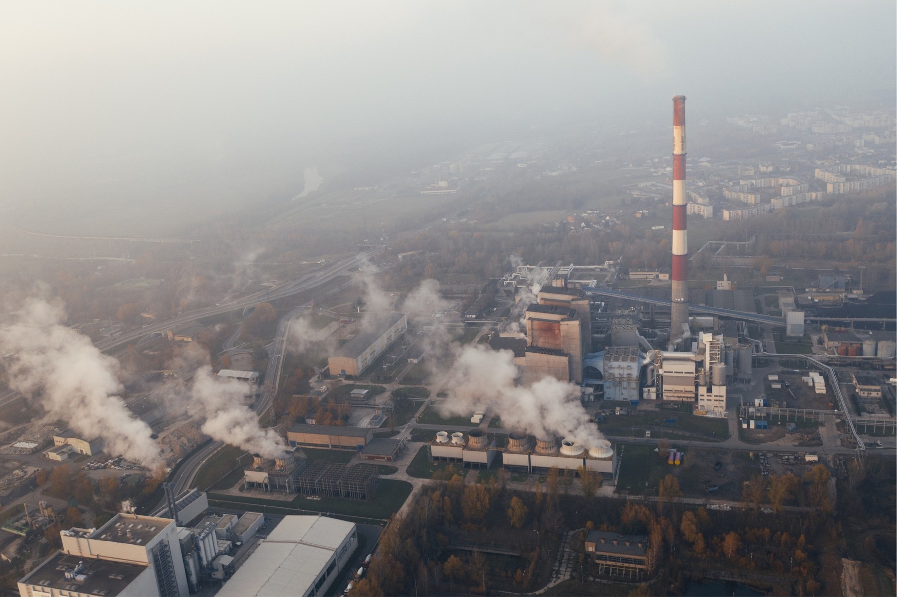 Aerial view of factories and their smoke emissions