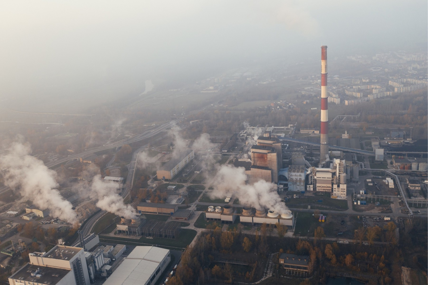 Aerial view of factories and their smoke emissions