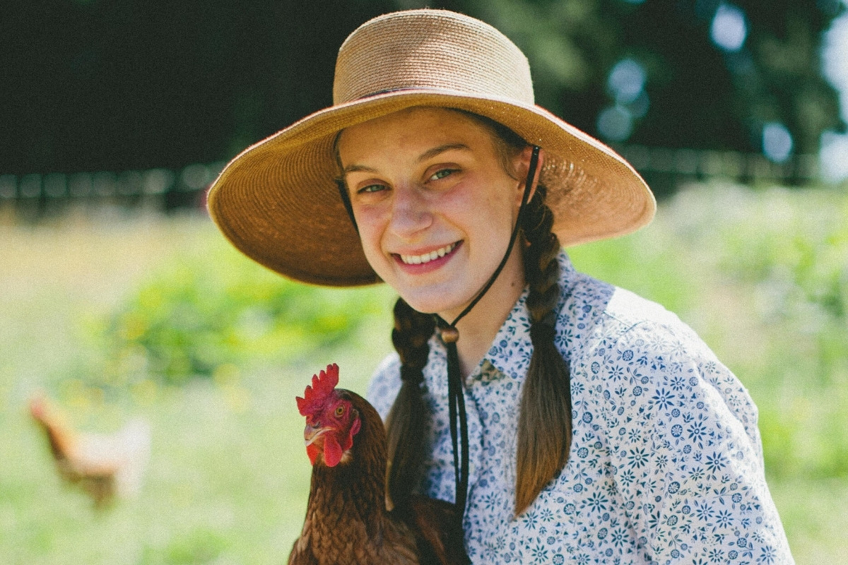 Portrait photo of Hannah Mueller holding chicken