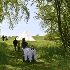 Nature Academy class walking, pulling a cart of nets behind them.