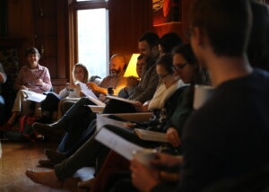 people gathered in a small group, having a discussion and laughing
